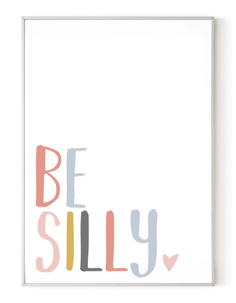 A portrait giclée print with ‘be silly’ message, on white paper in a white frame, using peachy pastel shades.