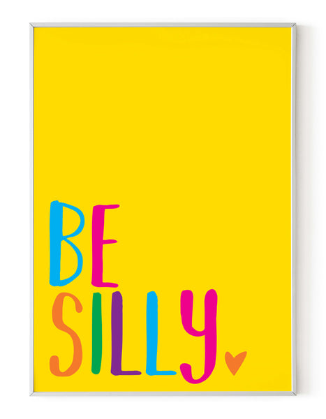 A portrait giclée print with ‘be silly’ message, on white paper in a white frame, using bold bright colours on a yellow background.