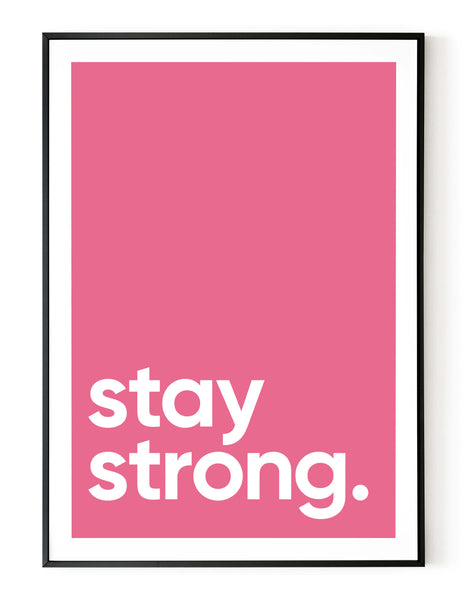 A portrait ‘stay strong’ giclée print, on white paper in a black frame, using a pink shade.