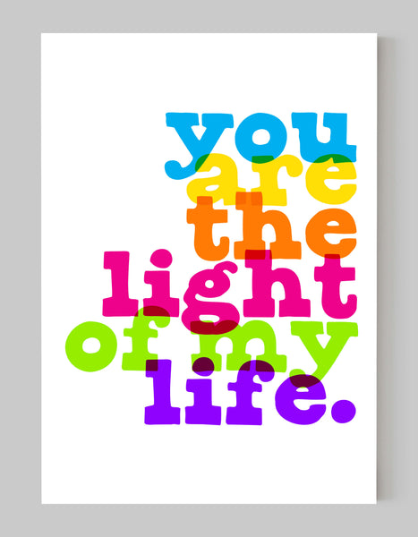 A portrait ‘you are the light of my life’ giclée print, on white paper in a black frame, using bright rainbow inks overlapped.